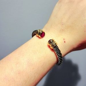 A Joan Rivers, OS,sterling silver with a hint of plated gold&purple CZ diamonds.